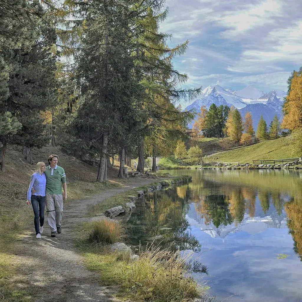 Hikers by the lake in Grächen.